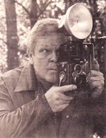 Caption: Douglas Hamm checks the view through the "old crank" the first camera he bought several years ago. Hamm has is a recognized artist in commercial and art photography.